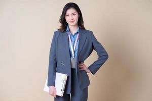 Portrait of young Asian business woman on background photo