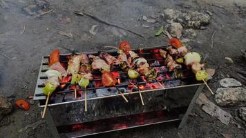 Barbecue skewers meat kebabs with vegetables on flaming grill, delicious food photo
