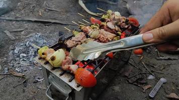 Barbecue skewers meat chicken and pork with vegetables on flaming grill, delicious food photo