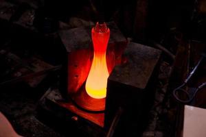 Glassworks glass manufacturing, process of forming a decorative vase photo