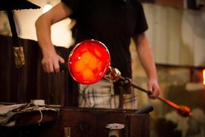 Glassworks glass manufacturing, process of forming a decorative vase photo