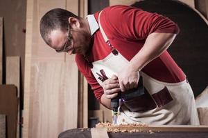 Carpenter at work in the workshop photo