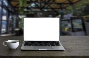 Front view of open laptop computer notebook with blank monitor white screen display on work table desk. Workspace office modern for job business online communication. photo