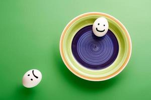 Egg smileys with different emotions. Simple good and evil concept with eggs. photo