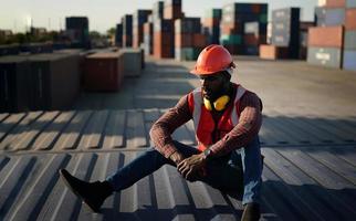 Engineer or supervisor checking and control loading Containers box from Cargo at harbor. Foreman control Industrial Container Cargo freight ship at industry. Transportation and logistic concept. photo