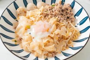 dried spicy noodles with minced pork, meatballs and egg