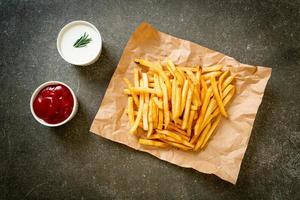 French fries with sour cream and ketchup photo