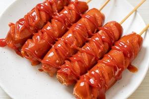 fried sausage skewer with ketchup photo