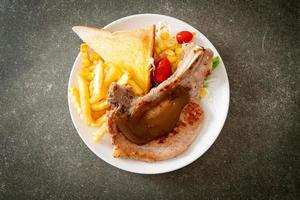 pork chop steak with chips and mini salad photo
