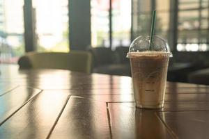 caramel macchiato coffee cup in coffee shop photo