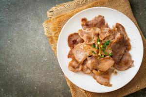 grilled pork neck sliced on plate photo