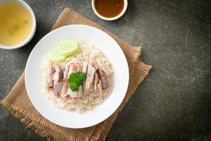 Hainanese Chicken Rice or steamed rice with chicken photo