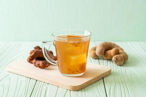 Delicious sweet drink tamarind juice and ice cube photo