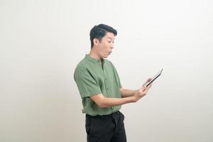 young Asian man using tablet photo