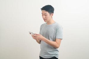 young Asian man using or talking smartphone and mobile phone photo