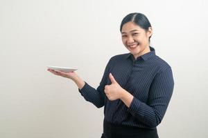 Asian woman with empty plate on hand photo