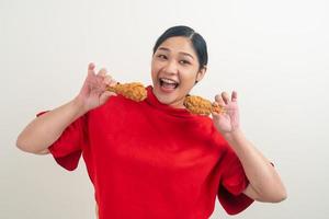 Asian woman with fried chicken on hand photo