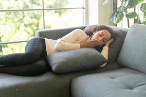 Latin woman sleeping on sofa photo