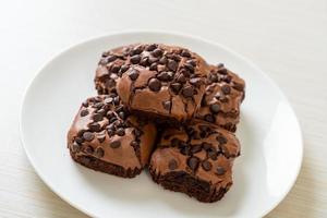 dark chocolate brownies topped by chocolate chips photo
