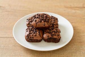 dark chocolate brownies topped by chocolate chips photo