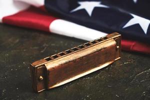Harmonica on the background of the flag of the United States of America. Musical instrument.Stars and stripes. photo
