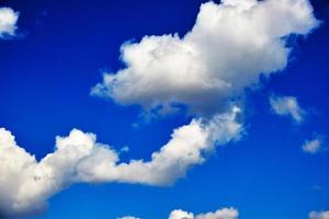 Background, Cumulus clouds in a bright blue sky.