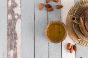 tea set and almon nut on old wood background photo