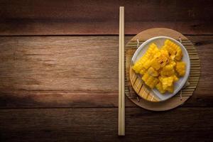 split corn on wood background photo