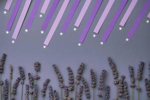 shooting star and dry lavender flower on purple violet background photo