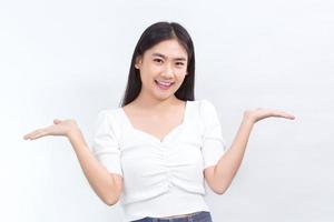 Portrait Asian cute woman is smiling and shows her hands to present something on the white background. photo