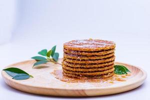 Wafer sprinkled with honey on wooden tray ready to serve photo