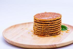 Wafer sprinkled with honey on wooden tray ready to serve photo