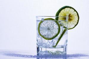 Glass of whiskey on a glass table photo