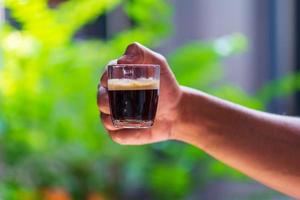 Hands are holding a cup of espresso coffee photo