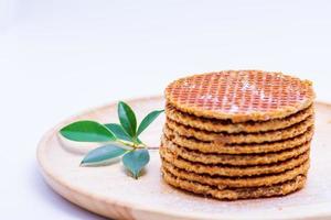 Wafer sprinkled with powder on wooden tray ready to serve photo