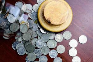 Close up coins sixth from the jar on the table. photo