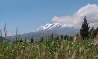 View of the Cayambe volcano from the town of Olmedo in the province of Cayambe during a sunny morning photo