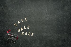 Sign with sale, Shopping and sales concept. Advertising message in black background. photo