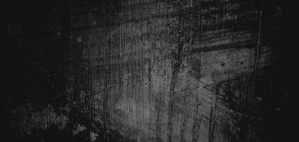 pared llena de arañazos. textura de cemento grungy para el fondo, pared oscura aterradora. pared negra foto