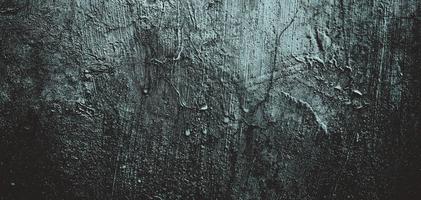 Wall full of scratches. Grungy cement texture for background, Scary dark wall.Black wall photo