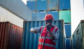 Engineer or supervisor checking and control loading Containers box from Cargo at harbor. Foreman control Industrial Container Cargo freight ship at industry. Transportation and logistic concept. photo