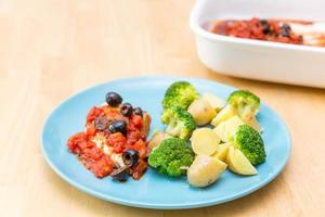 Chicken breast in olive and tomato sauce with broccoli photo