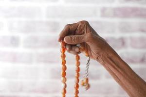 Close up of senior women hand praying at ramadan photo