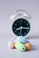 easter concept with egg and a clock on table photo