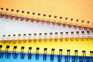 high angle view of colorful notepad on red background photo