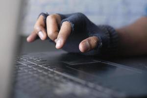 hacker hand stealing data from laptop top down photo