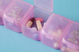 top view of medical pill box on color background photo