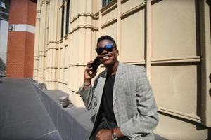 Afro American man having fun walking in city center - Happy young guy enjoying time a sunset outdoor - Millennial generation lifestyle and positive people attitude concept photo