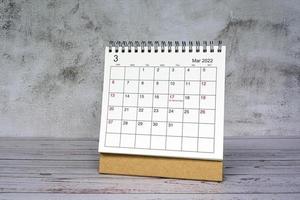 White March 2022 calendar on wooden desk. 2022 new year concept. photo