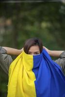 Ukrainian flag on half of the girl's face for peace and freedom Hopes of Ending the War of Ukraine and Russia photo